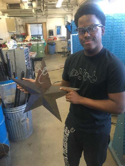 Demitri posing with the metal star he created
